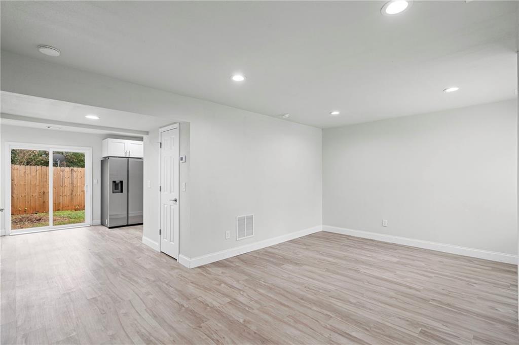 1342 North Hampton Road Alpharetta, GA 30009 - Photo 11 of 29 wooden floor in an empty room with a window