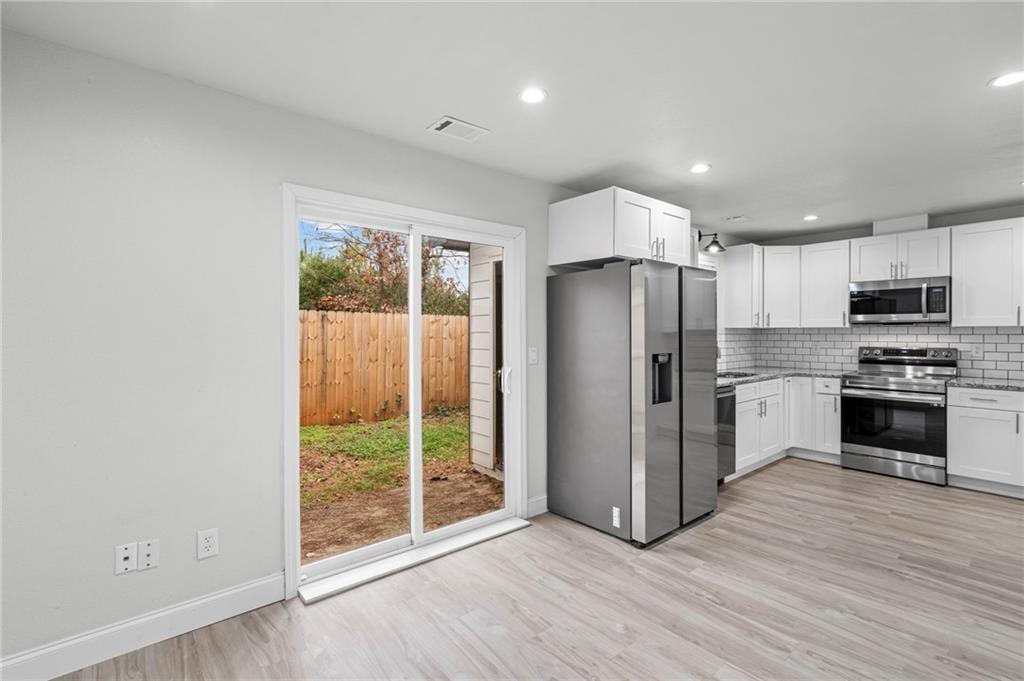1342 North Hampton Road Alpharetta, GA 30009 - Photo 13 of 29 a kitchen with stainless steel appliances a refrigerator sink and microwave