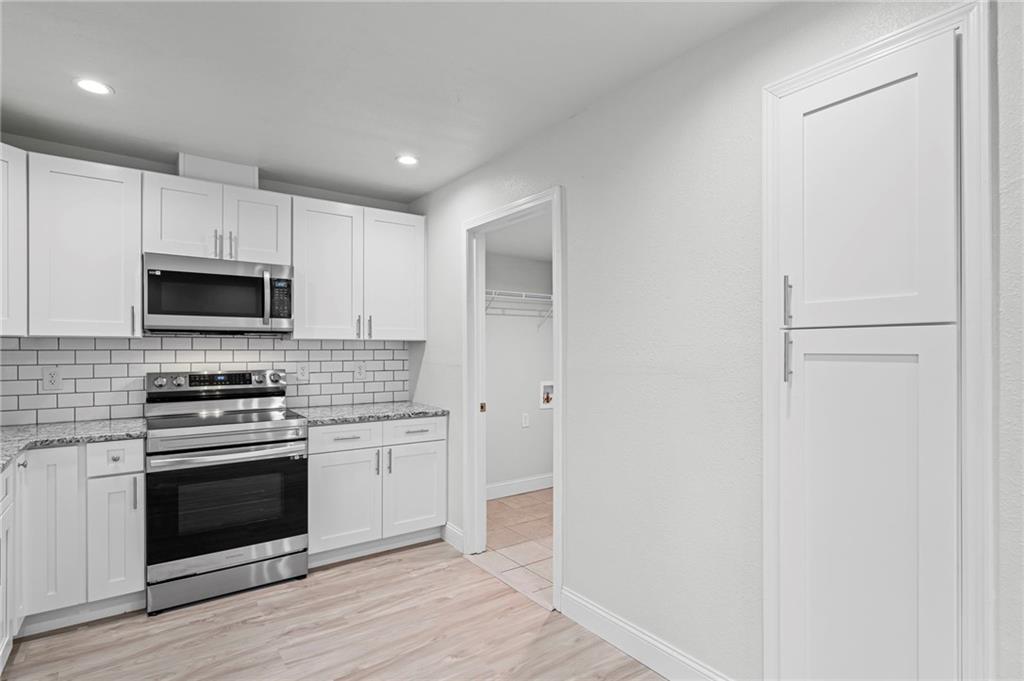 1342 North Hampton Road Alpharetta, GA 30009 - Photo 16 of 29 a kitchen with a stove and a microwave