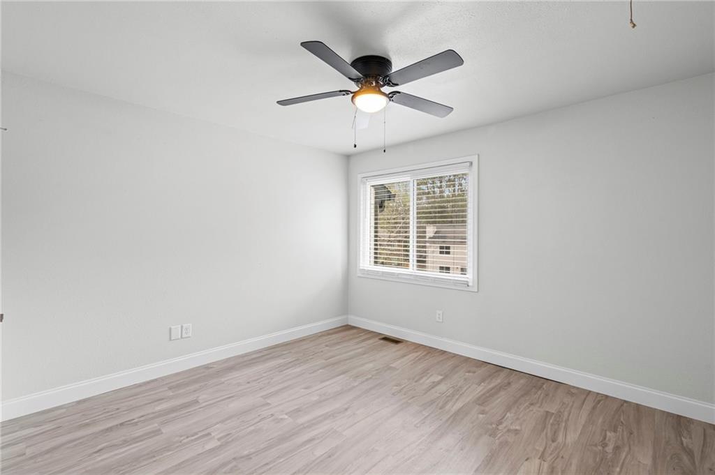 1342 North Hampton Road Alpharetta, GA 30009 - Photo 21 of 29 wooden floor in an empty room with a window
