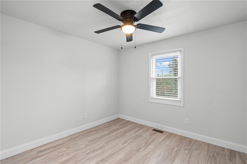 1342 North Hampton Road Alpharetta, GA 30009 - Photo 23 of 29 wooden floor in an empty room with a window