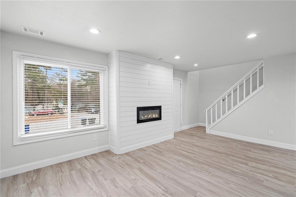 1342 North Hampton Road Alpharetta, GA 30009 - Photo 10 of 29 a view of an empty room with wooden floor and a window