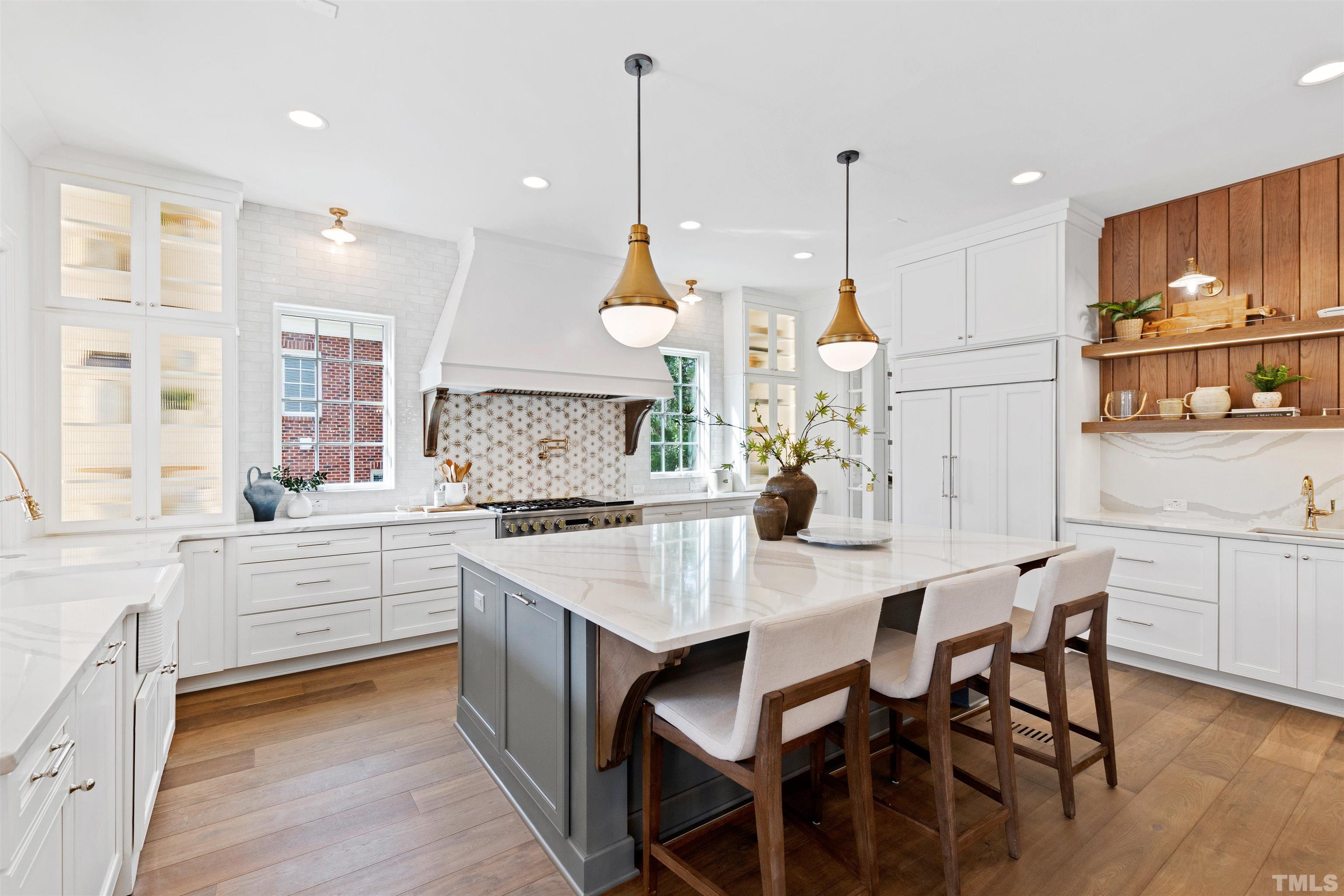 1716 Nottingham Road Raleigh, NC 27607 - Photo 14 of 78 a kitchen with stainless steel appliances granite countertop a stove a sink a kitchen island and chairs with wooden floor