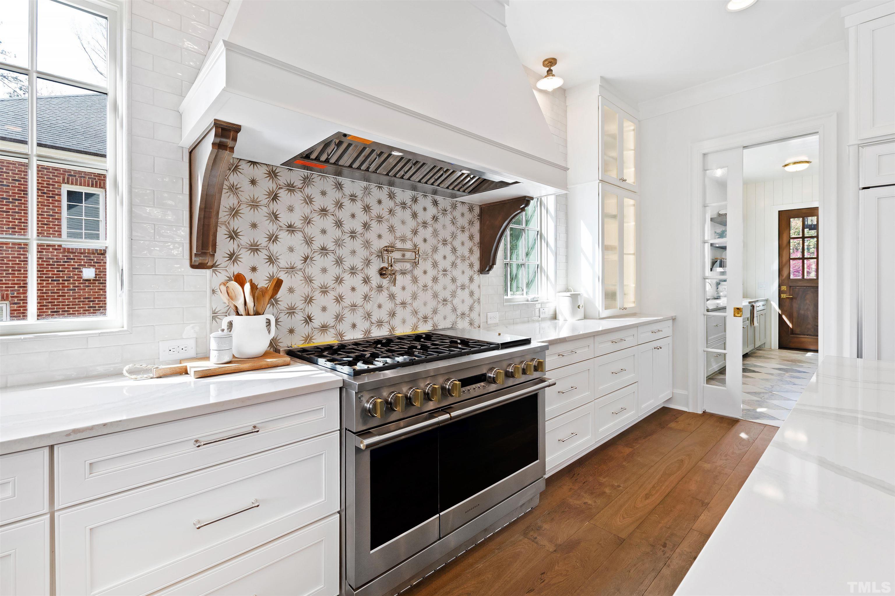 1716 Nottingham Road Raleigh, NC 27607 - Photo 17 of 78 a kitchen with stainless steel appliances a stove and a sink