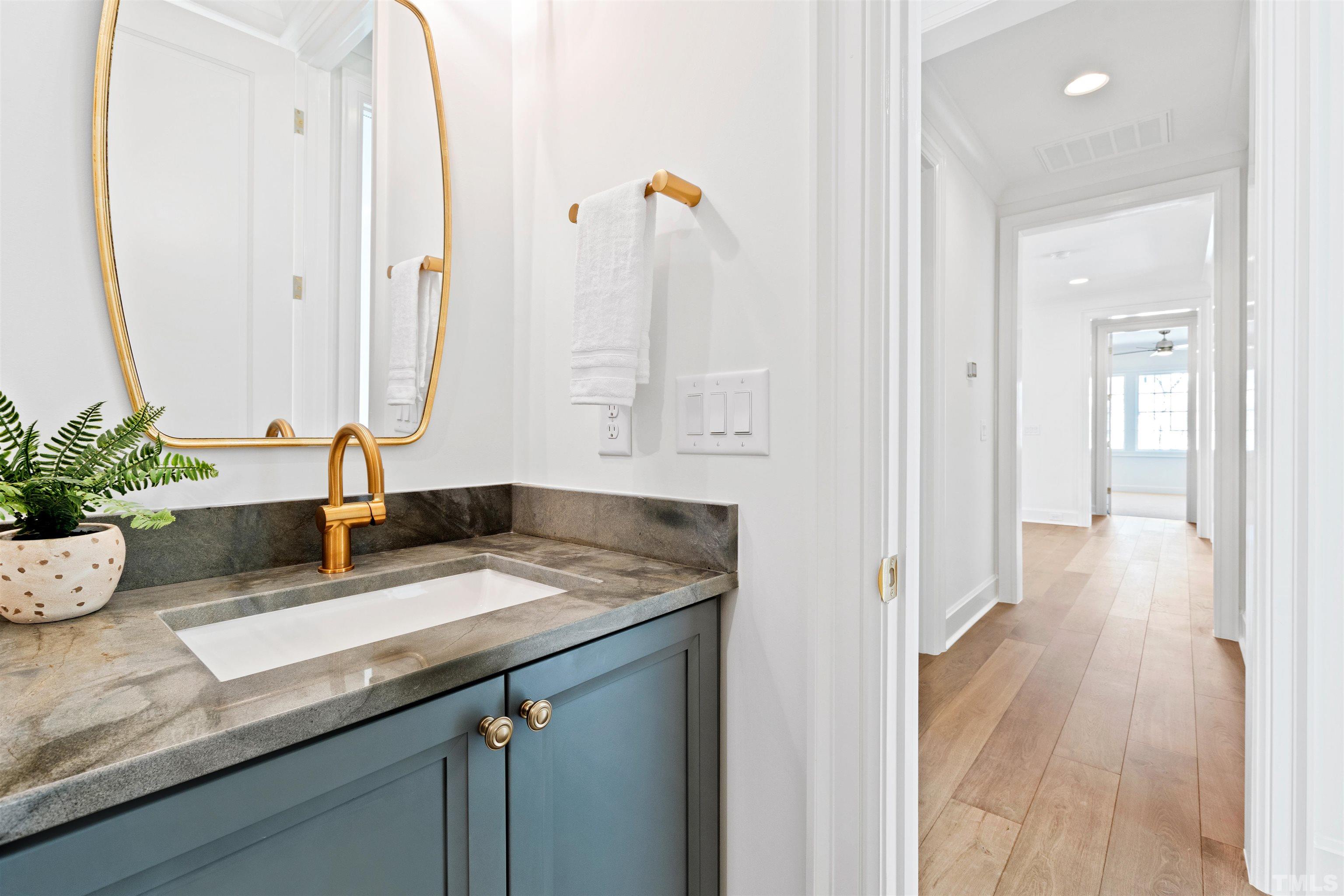 1716 Nottingham Road Raleigh, NC 27607 - Photo 54 of 78 a bathroom with a granite countertop sink a mirror and vanity