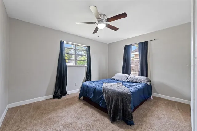 a bedroom with a bed and window