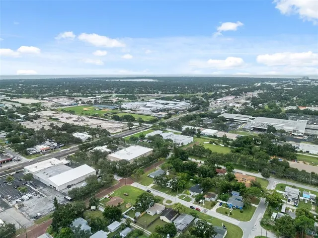 an aerial view of residential building with green space