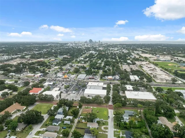 an aerial view of residential building with green space