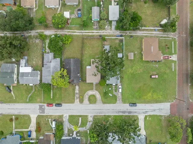 an aerial view of a house with a garden and lake view