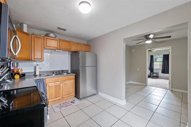 a kitchen with stainless steel appliances granite countertop a refrigerator and a stove top oven