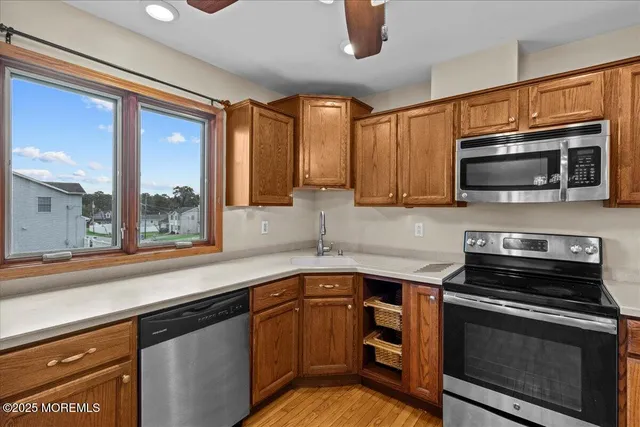 a kitchen with stainless steel appliances a stove sink microwave and cabinets