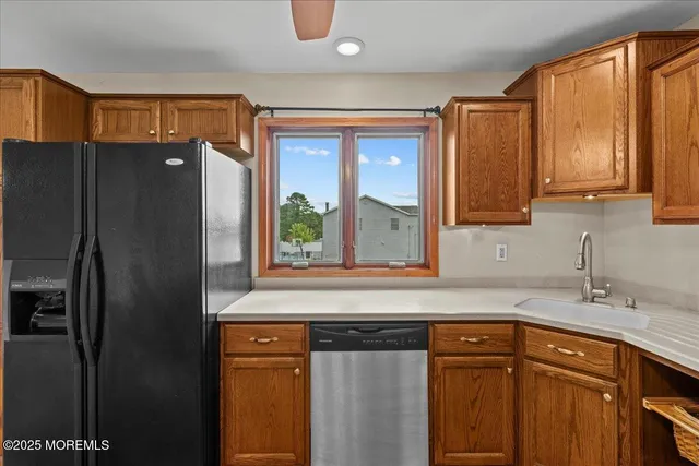 a kitchen with stainless steel appliances granite countertop a refrigerator and a sink