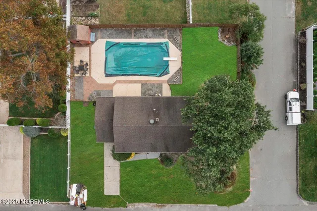 an aerial view of a house with a yard