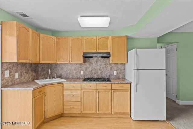 a kitchen with a sink a refrigerator a washer and dryer