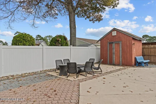 a view of backyard of house with seating space