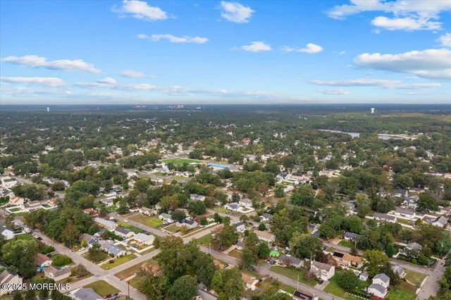 an aerial view of residential building with green space