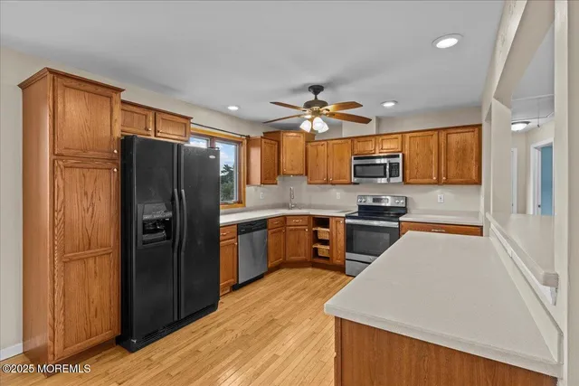 a kitchen with granite countertop a refrigerator stove top oven and sink
