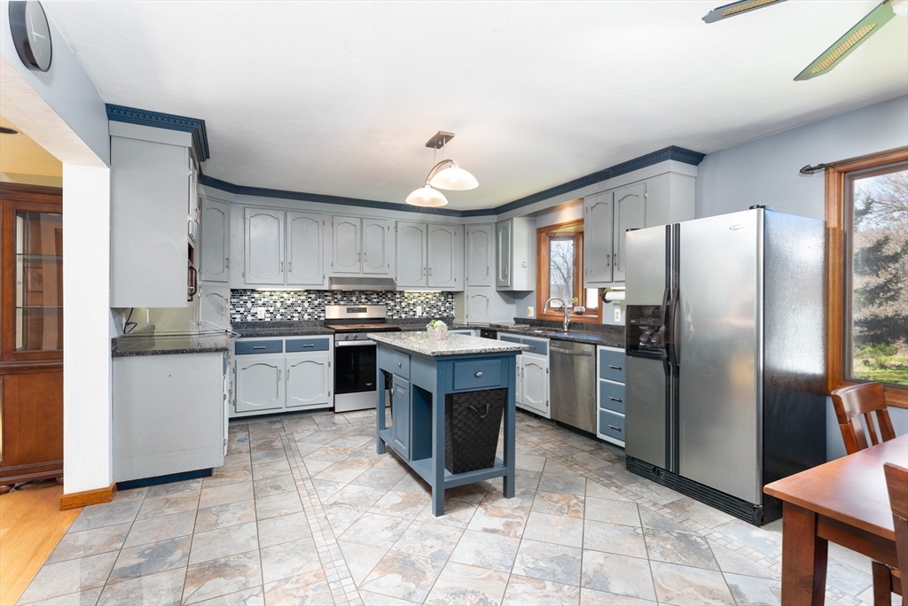 27 Dudley Road Sutton, MA 01590 - Photo 12 of 42 a kitchen with a refrigerator a sink a counter top space and cabinets