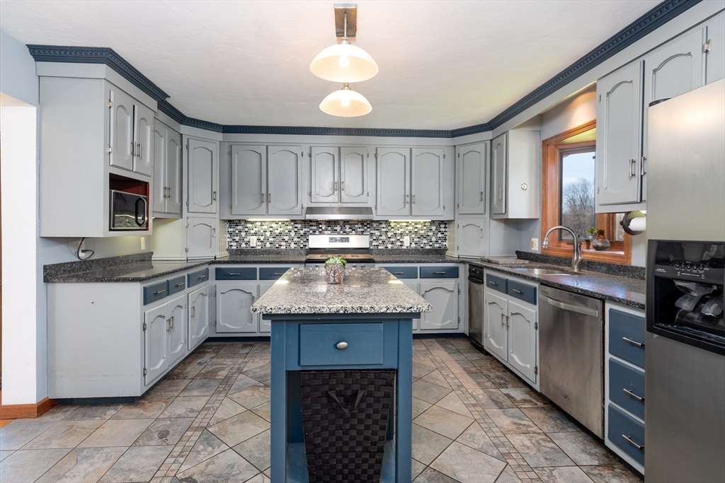27 Dudley Road Sutton, MA 01590 - Photo 13 of 42 a kitchen with granite countertop a sink stainless steel appliances and cabinets