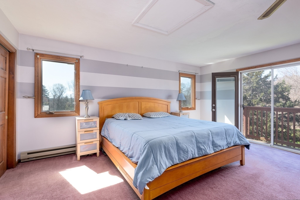 27 Dudley Road Sutton, MA 01590 - Photo 19 of 42 a bedroom with a bed lamp and window