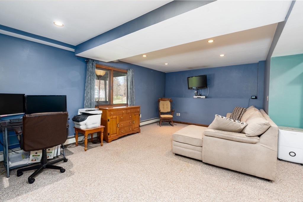 27 Dudley Road Sutton, MA 01590 - Photo 24 of 42 a living room with furniture and a window