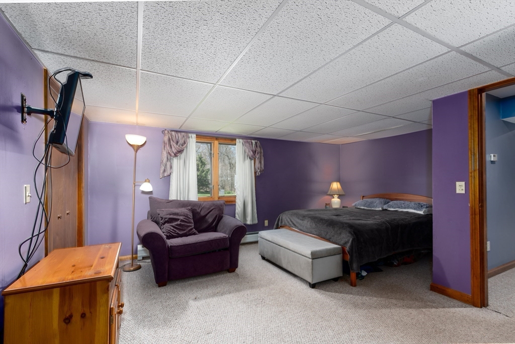 27 Dudley Road Sutton, MA 01590 - Photo 27 of 42 a bedroom with furniture and a couch