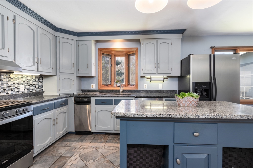 27 Dudley Road Sutton, MA 01590 - Photo 4 of 42 a kitchen with granite countertop a sink stainless steel appliances and cabinets