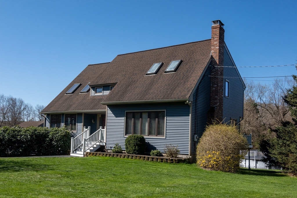 27 Dudley Road Sutton, MA 01590 - Photo 42 of 42 a front view of a house with a garden and yard