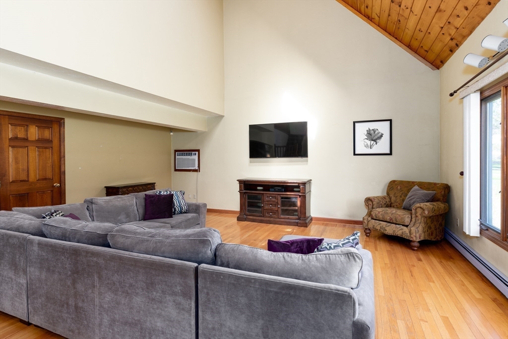 27 Dudley Road Sutton, MA 01590 - Photo 7 of 42 a living room with furniture and a flat screen tv