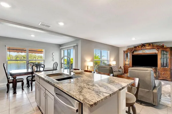 a kitchen with a table chairs and a refrigerator