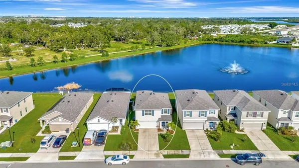 an aerial view of residential houses with outdoor space and swimming pool