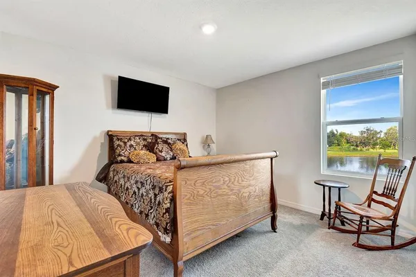 a bed room with a bed and a chair