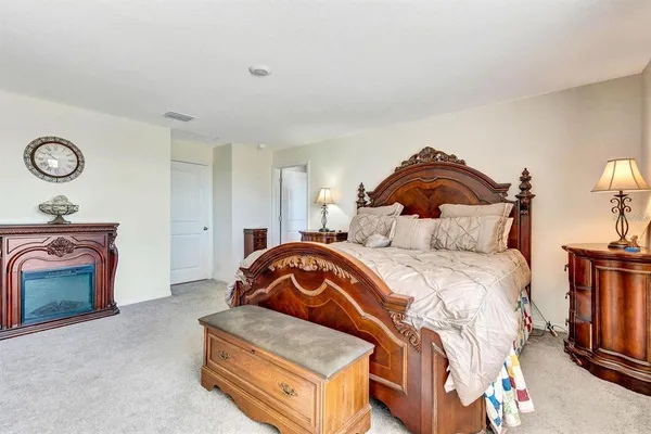 a bedroom with a bed and a fireplace