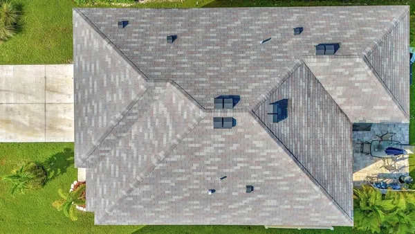 a aerial view of a house with a yard
