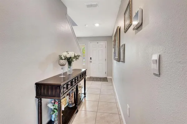 a view of a hallway with chandelier