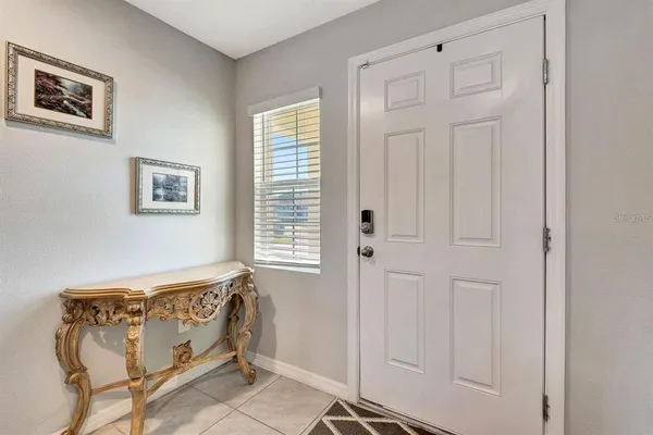 a bedroom with windows and closet