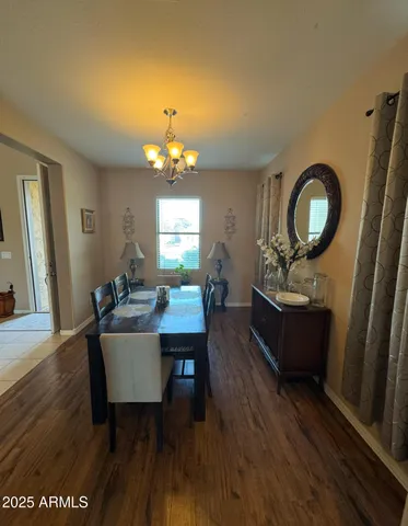 a living room with furniture a dining table and a chandelier
