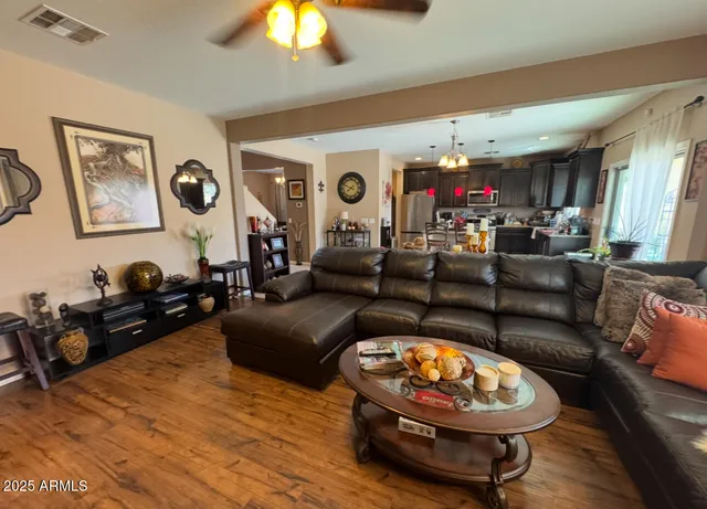 a living room with furniture a flat screen tv and a window