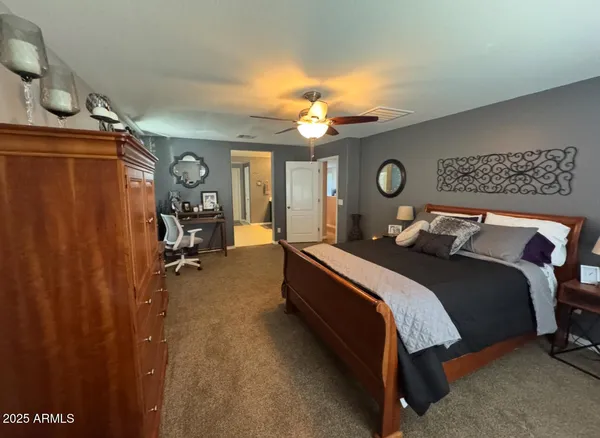 a bedroom with a bed and a mirror