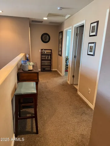a view of a patio with a table and chairs under an umbrella