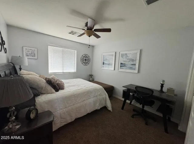 a living room with furniture wooden floor and a floor to ceiling window