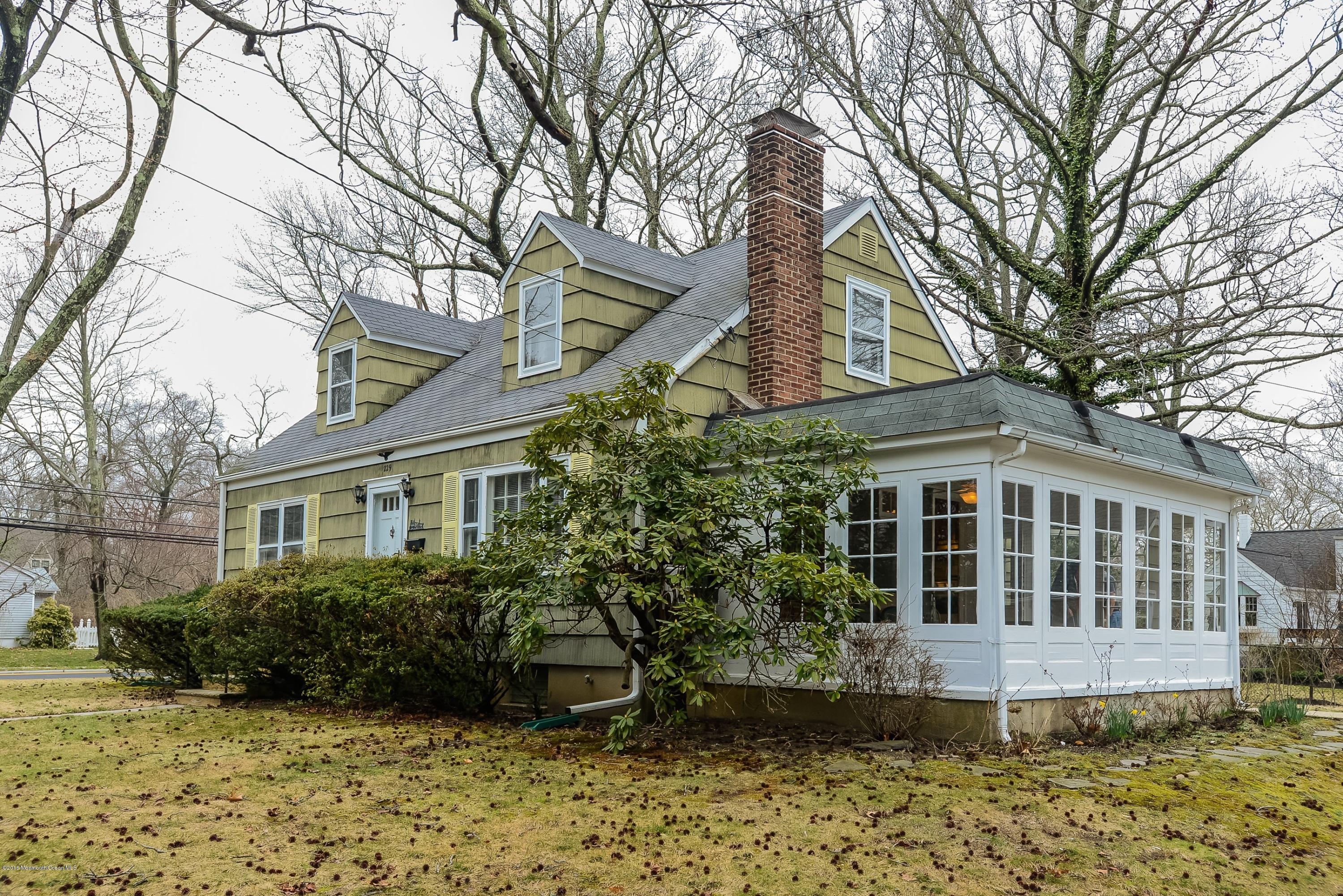 229 Pinecrest Road Oakhurst, NJ 07755 - Photo 1 of 12 a house view with a garden space