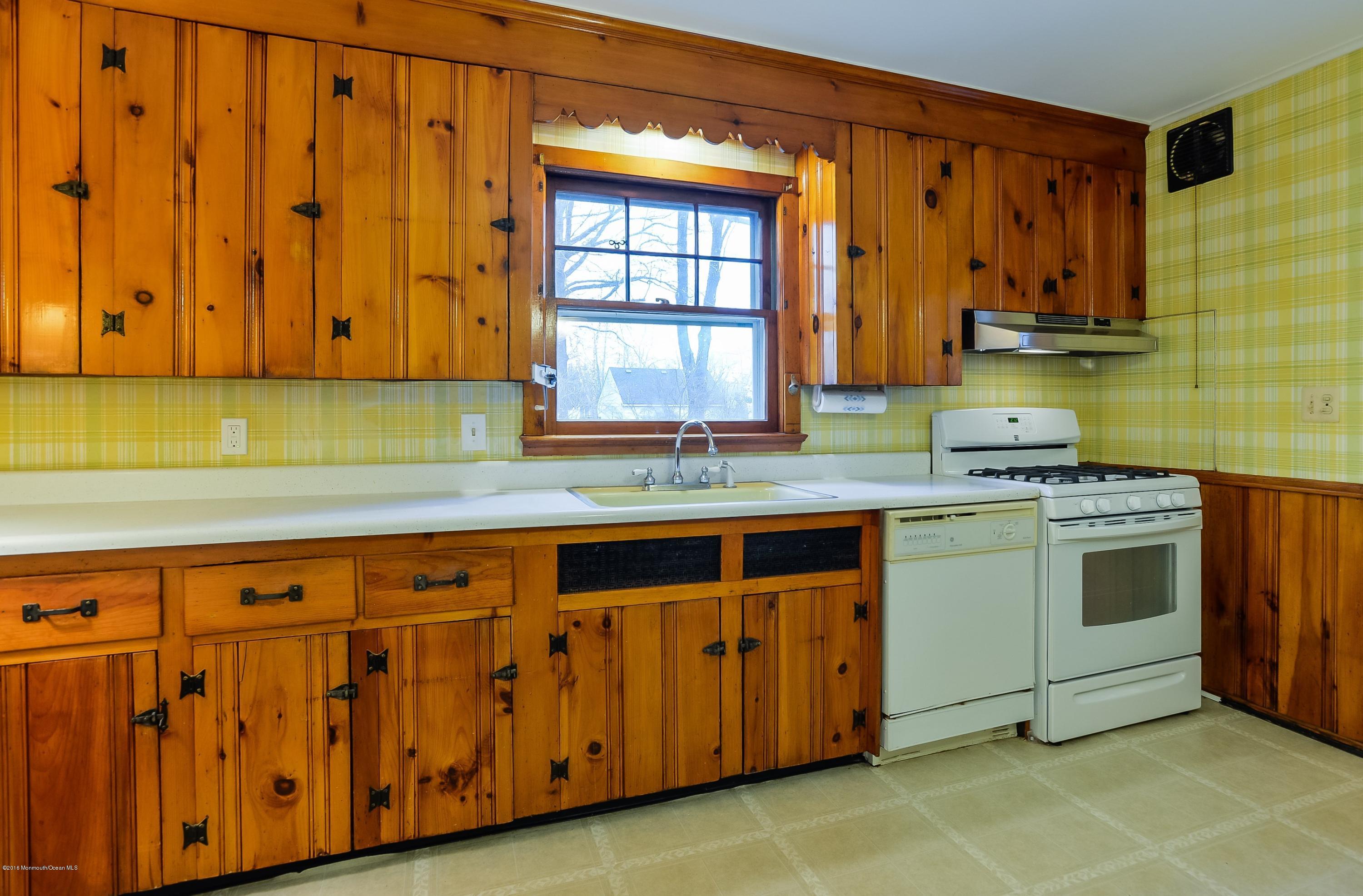 229 Pinecrest Road Oakhurst, NJ 07755 - Photo 4 of 12 a kitchen with stainless steel appliances granite countertop a sink a stove and a microwave