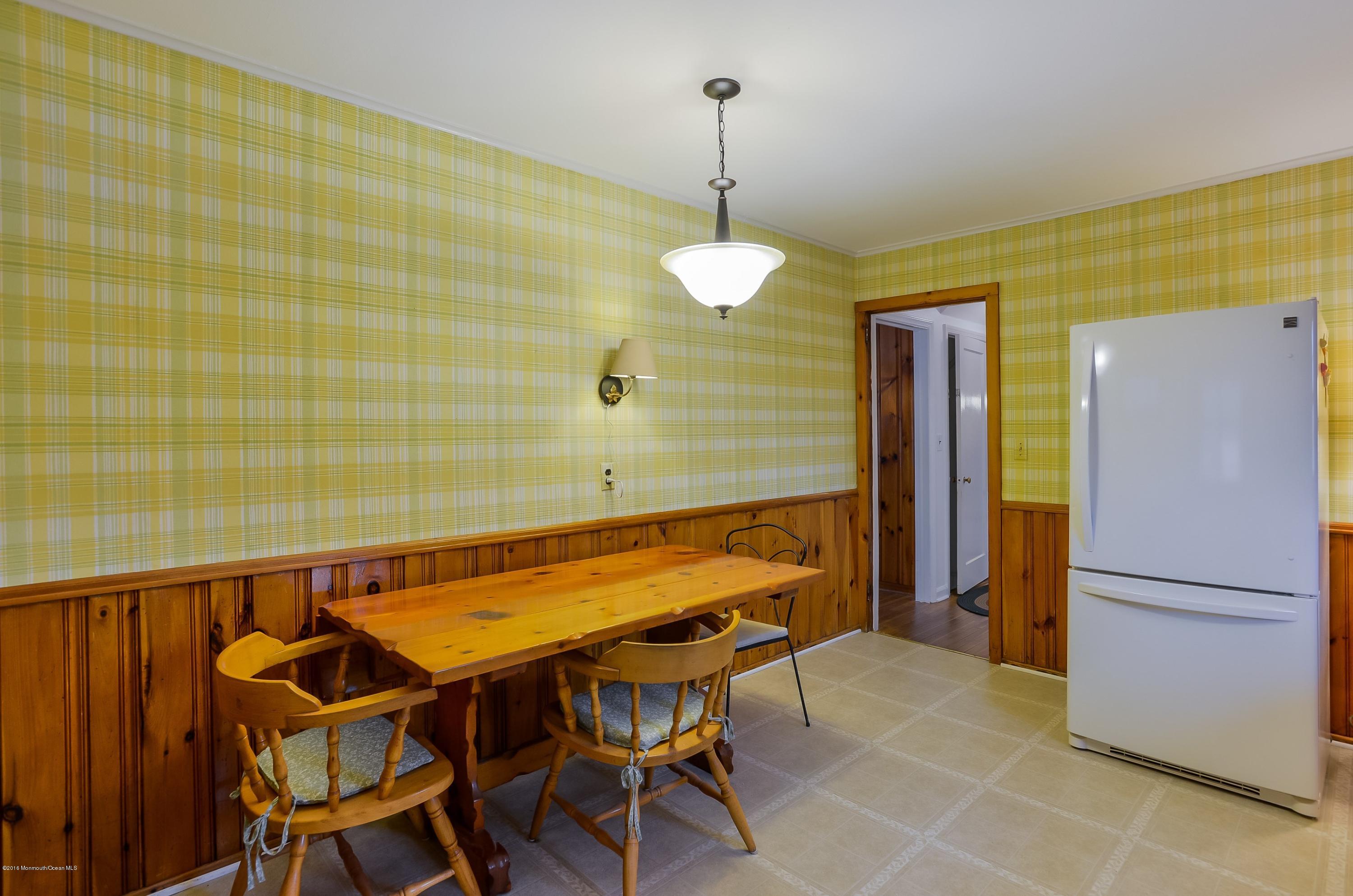 229 Pinecrest Road Oakhurst, NJ 07755 - Photo 5 of 12 a dining room with a table chairs and a refrigerator