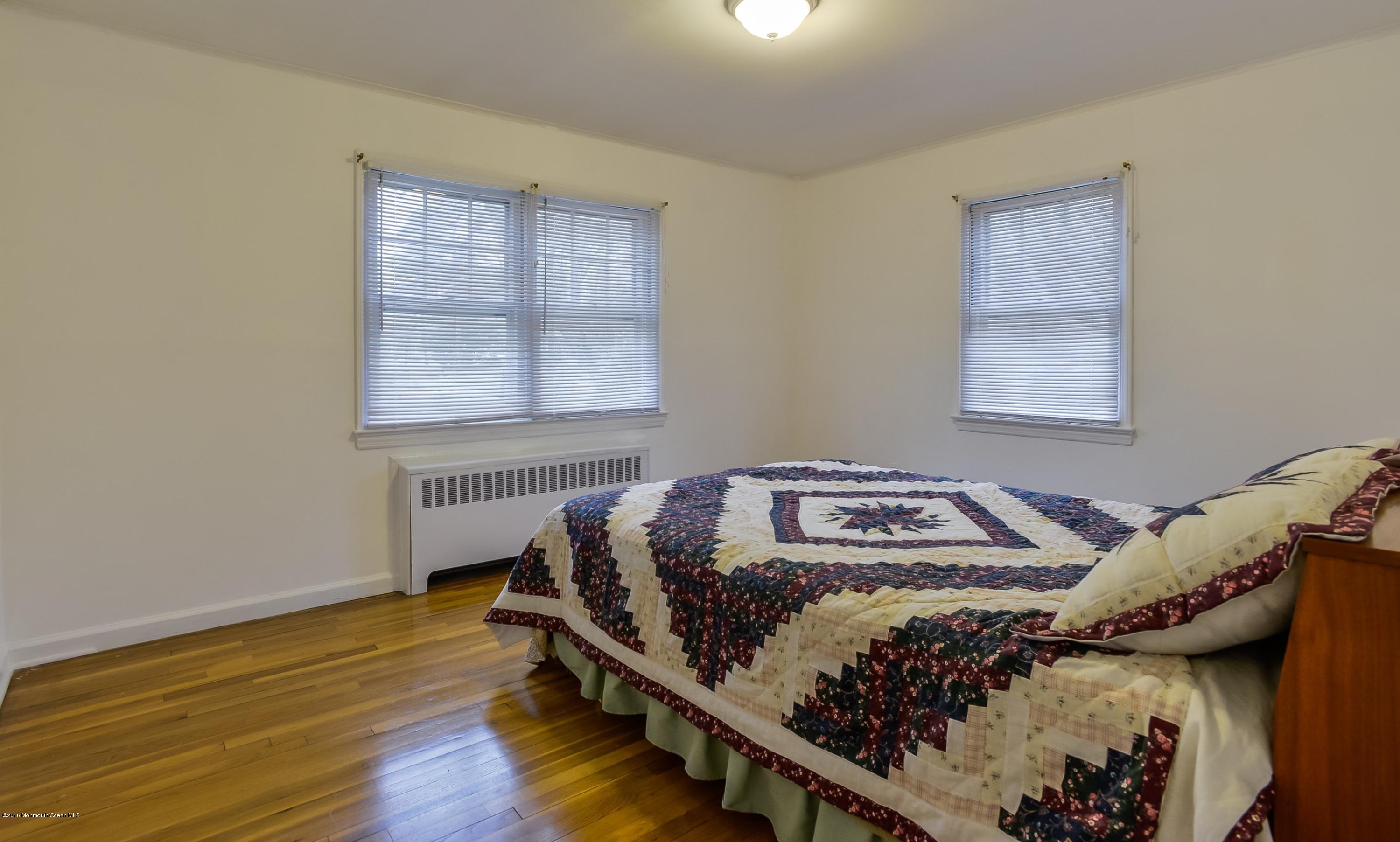 229 Pinecrest Road Oakhurst, NJ 07755 - Photo 6 of 12 a bedroom with a bed and a window