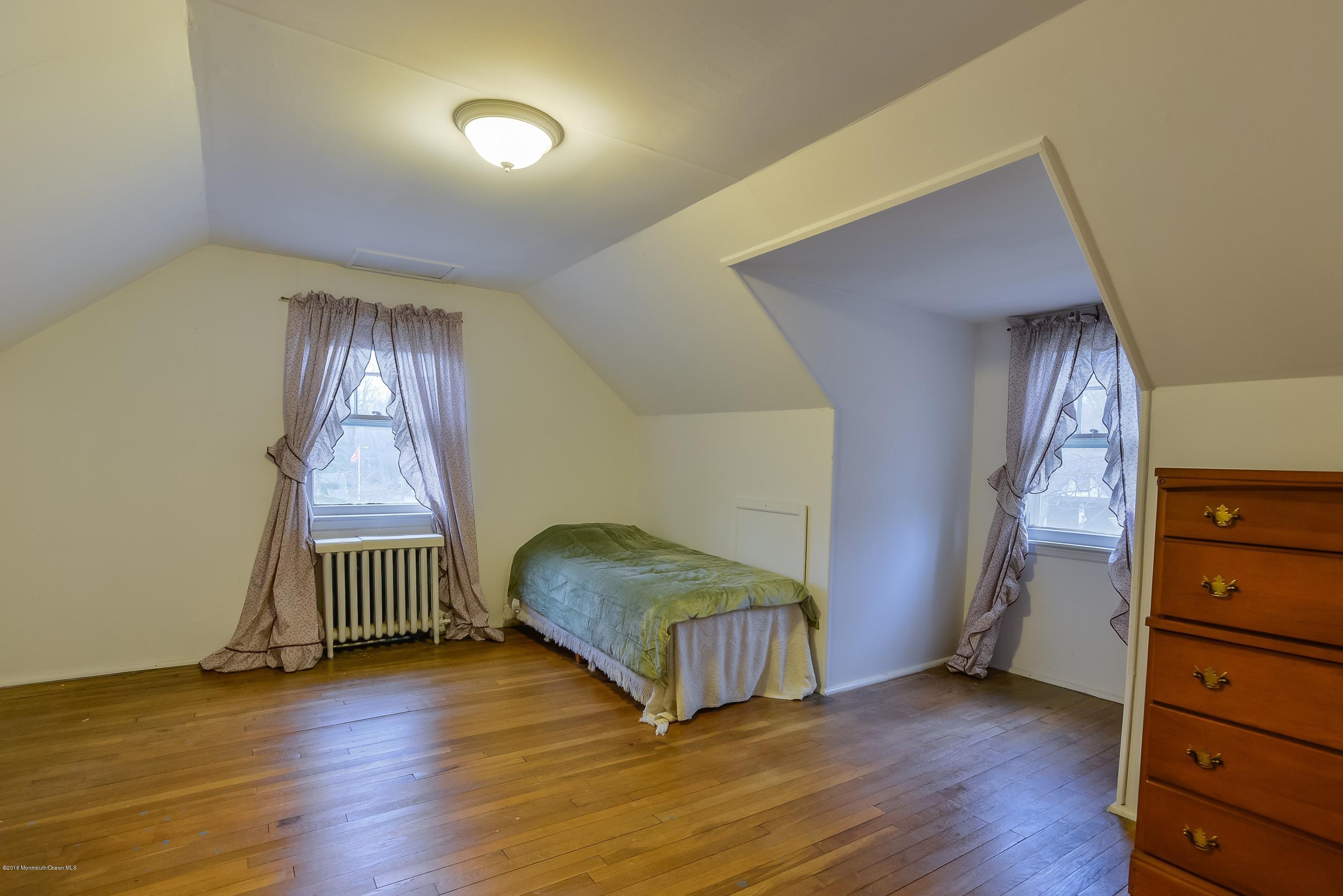 229 Pinecrest Road Oakhurst, NJ 07755 - Photo 8 of 12 a view of an empty room with wooden floor and a window