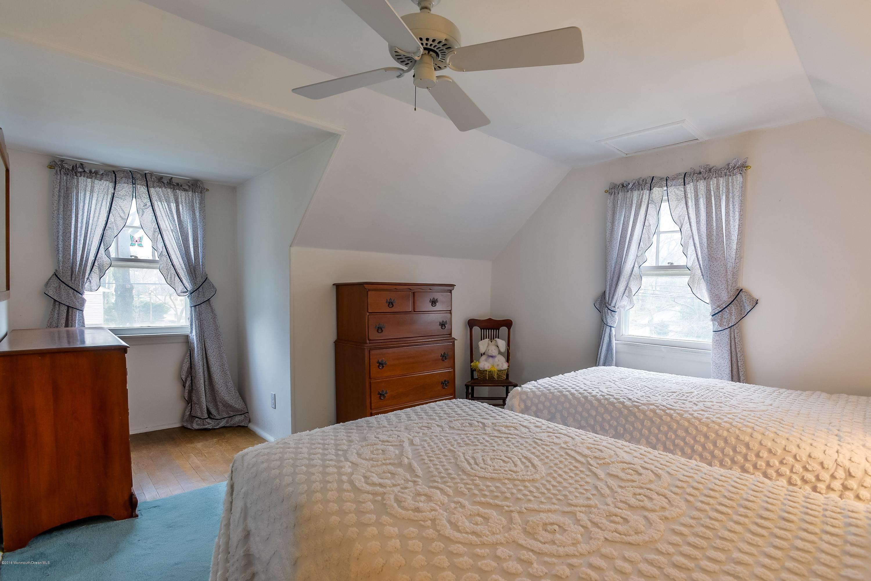 229 Pinecrest Road Oakhurst, NJ 07755 - Photo 9 of 12 a bedroom with a bed dresser and a window