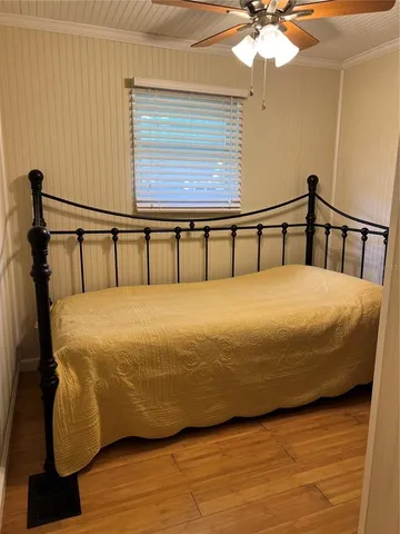 a large bed sitting in a bedroom next to a window