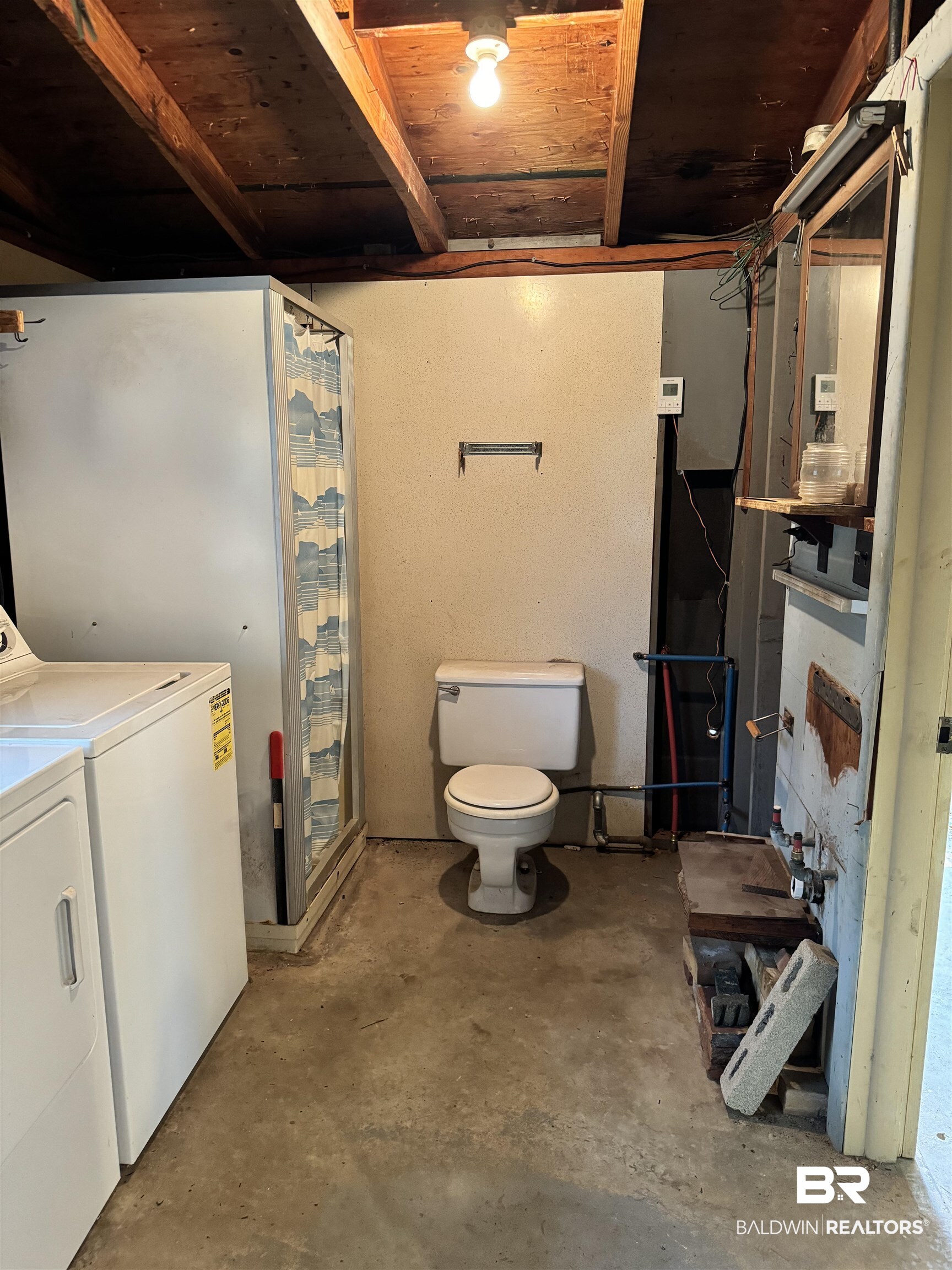 217 West Magnolia Avenue Foley, AL 36535 - Photo 17 of 21 Basement with washing machine and dryer and wooden ceiling