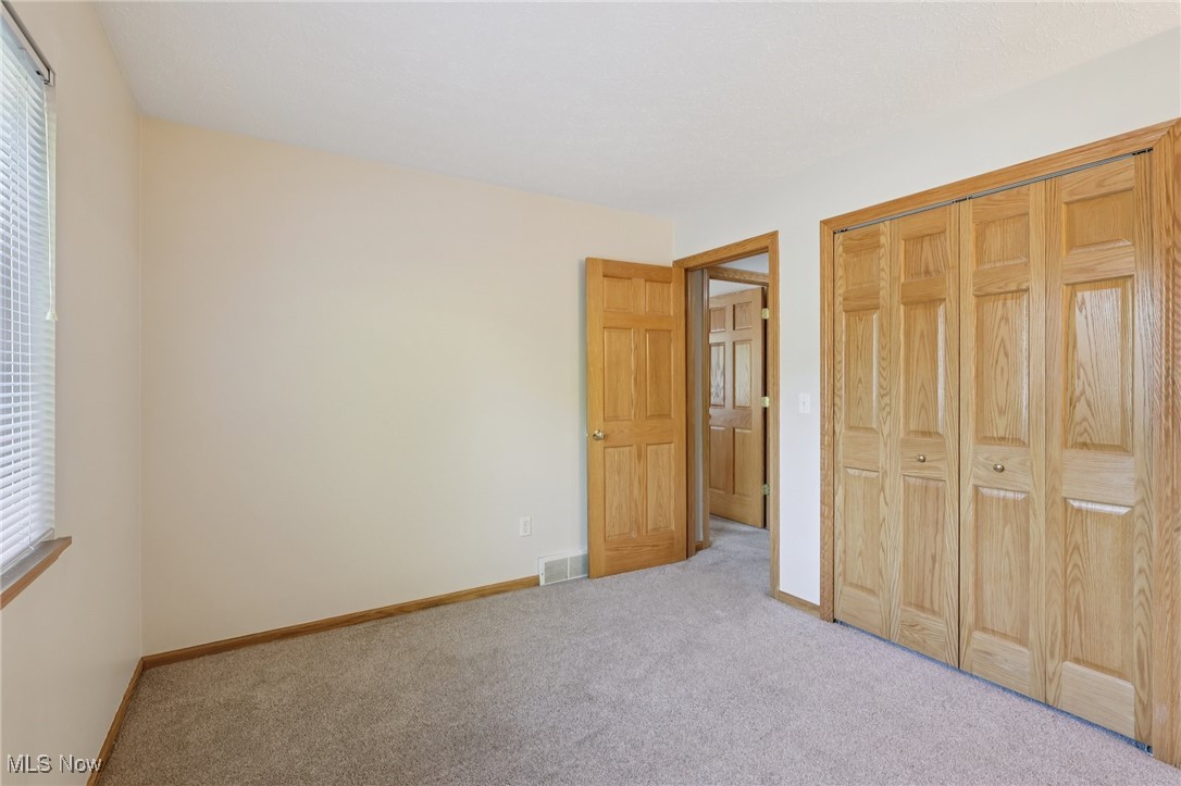 5877 Pearl Road Cleveland, OH 44130 - Photo 25 of 42 Unfurnished bedroom featuring carpet and a closet